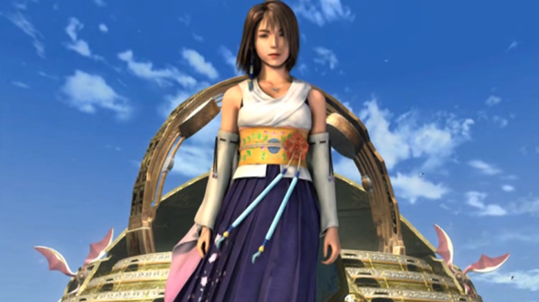 Yuna standing against blue sky background