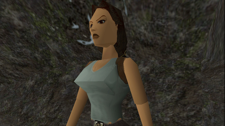 Lara stands among rocks