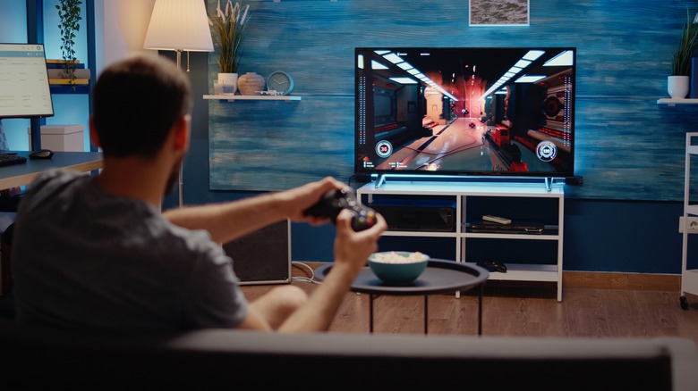 Man playing generic video game on TV