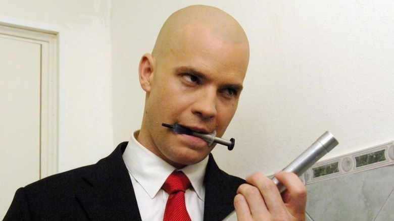 Agent 47 with syringe in mouth