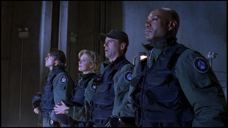 Teal'c and other soldiers standing in front of stargate