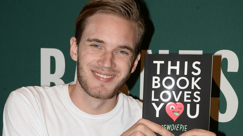 PewDiePie posing with his book This Book Loves You