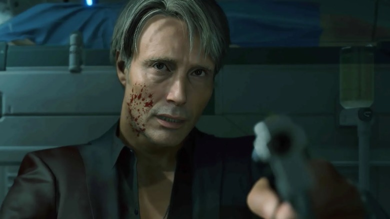 Mads Mikkelsen's character holding a gun