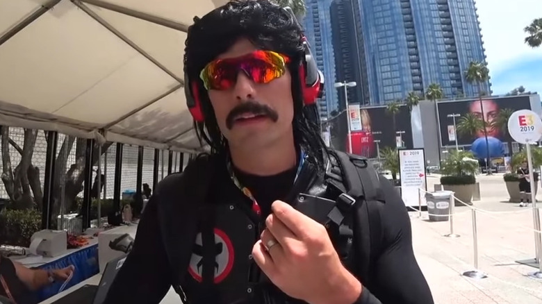 Dr. Disrespect standing at outdoor booth 