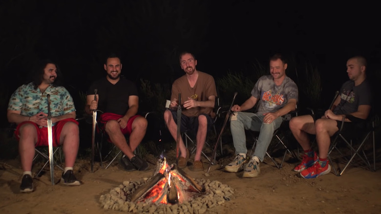 OTK members sitting around a campfire