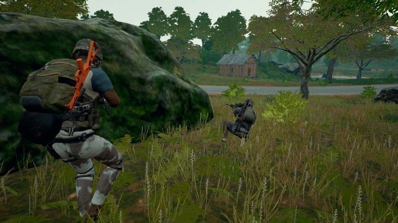 Two PUBG players hiding behind rock