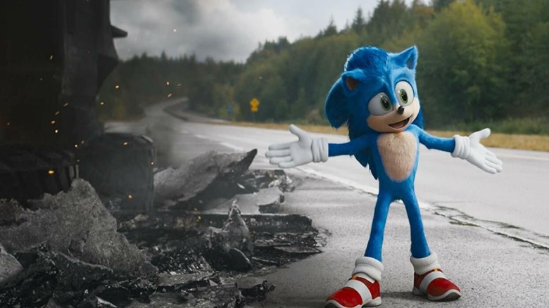 Sonic stands cheerfully next to a pile of rubble