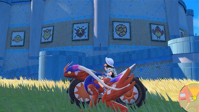 Pokémon trainer drives by the mosaics in Alfornada