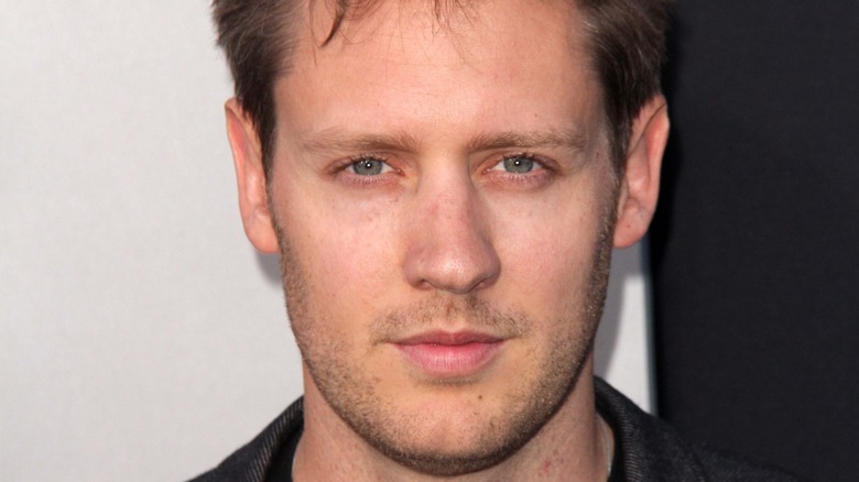 Neill Blomkamp staring ahead