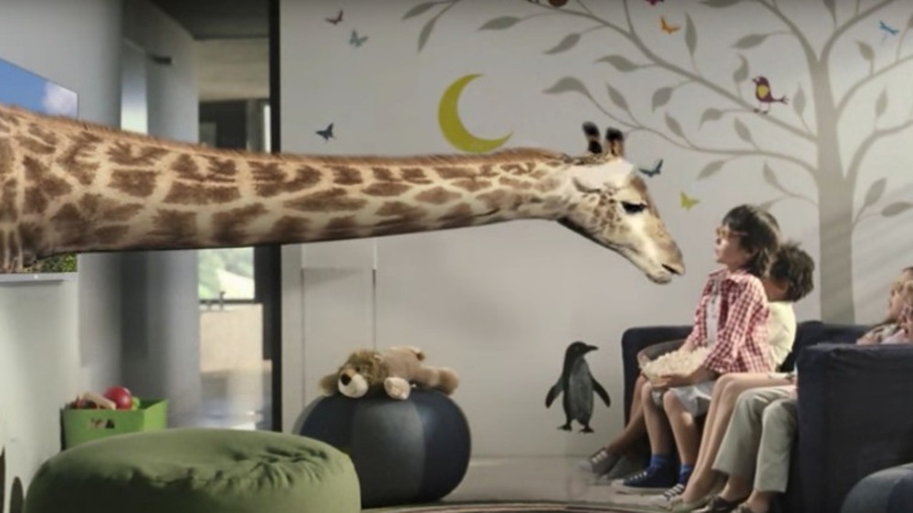 giraffe extends out of a TV