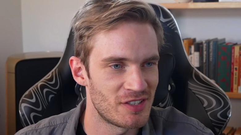 PewDiePie looks at a computer screen in his office