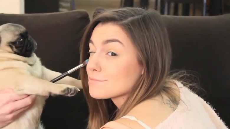 Maya the pug giving Marzia Kjellberg a makeover