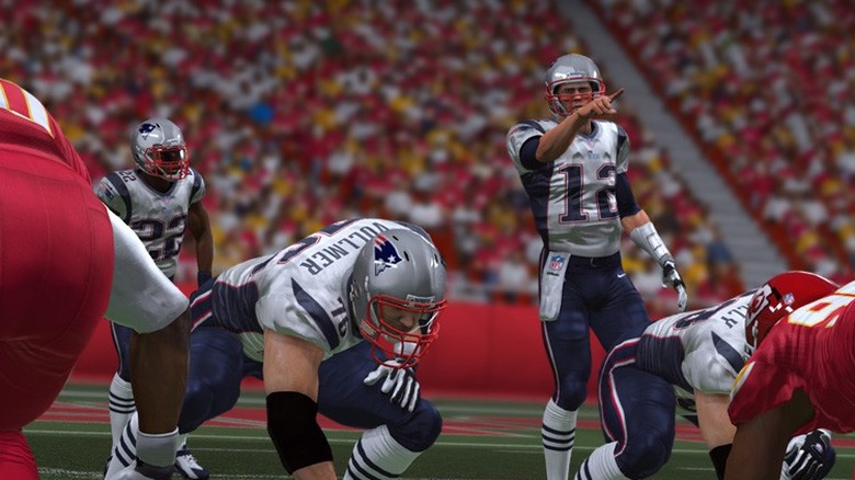 madden nfl player pointing with team members