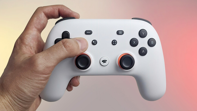 Hand holding Stadia controller