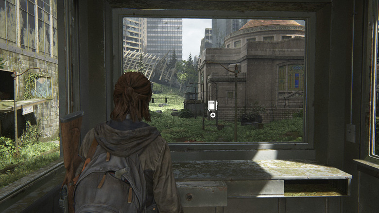 Ellie staring out window at ruined city