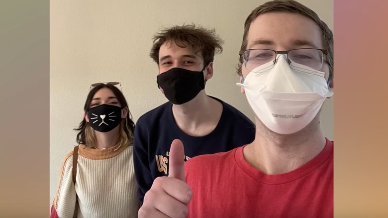 Terchnoblade posing for selfie with two other people wearing masks