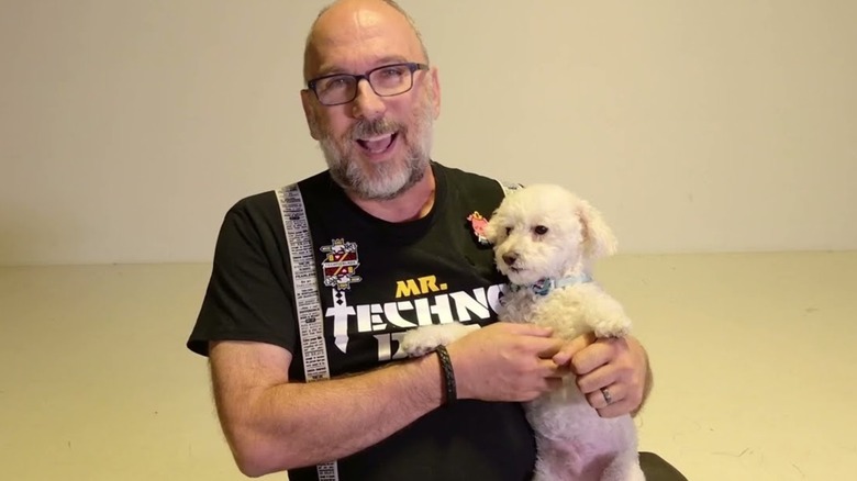 Technodad smiling and holding dog