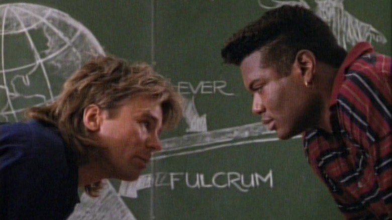 Richard Dean Anderson and Christopher Judge in front of a blackboard