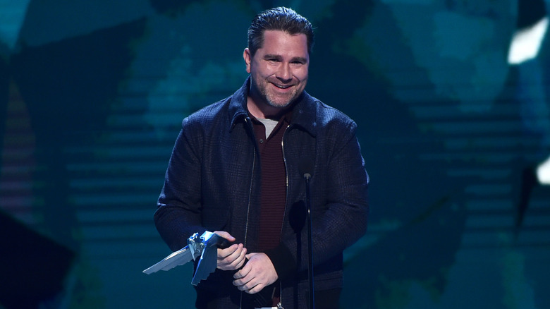 Roger Clark holding award at The Game Awards