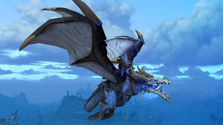 A screenshot from World of Warcraft, showing a character riding a grey and blue dragon in the air.