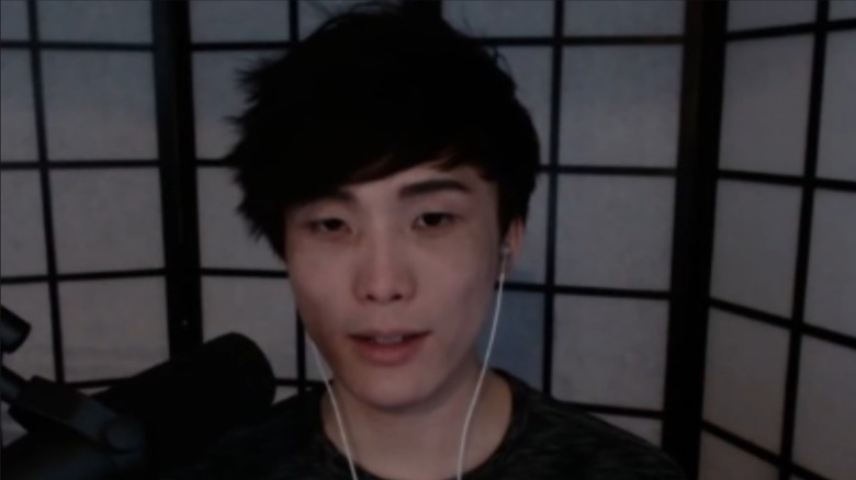 Sykkuno wearing white earbuds