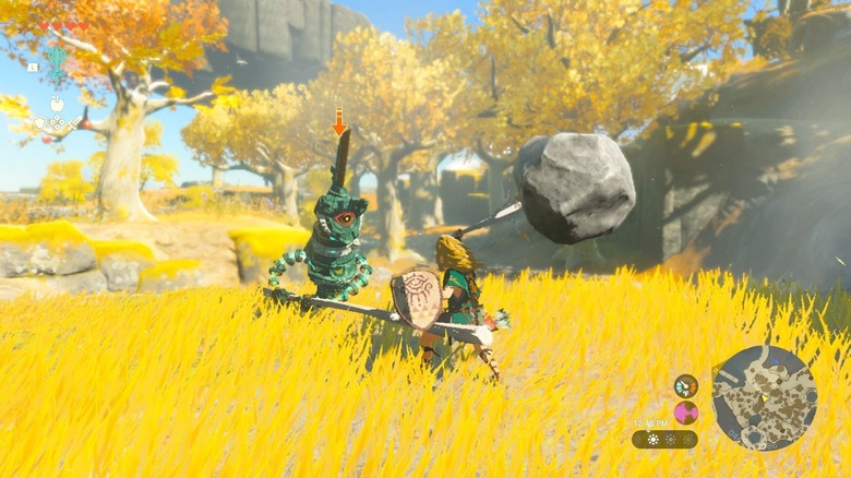 Link swinging fused weapon at enemy in forest